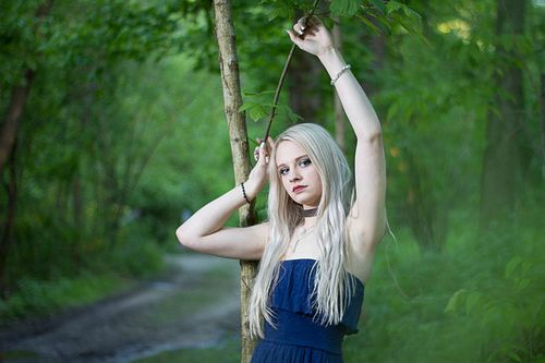 High-end editorial senior session with dramatic contrast and layered styling