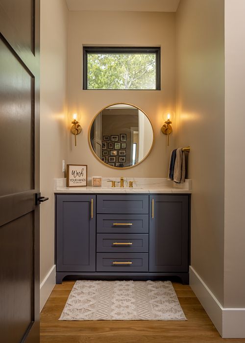 Powder room, satin brass wall sconces, custom blue vanity