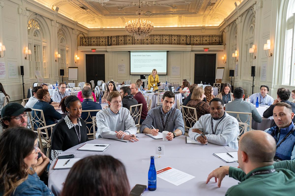 Corporate leadership roundtable discussion at The Bellevue Hotel in Philadelphia with professionals engaged in a collaborative workshop session.