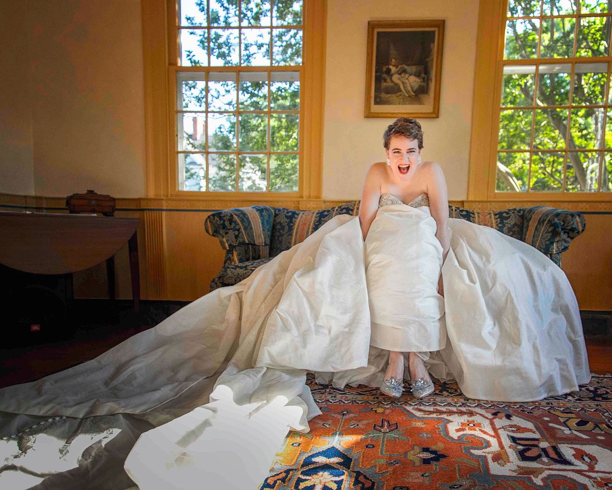 bride sitting on the couch smiling at polar Hill Mansion, Salisbury, md