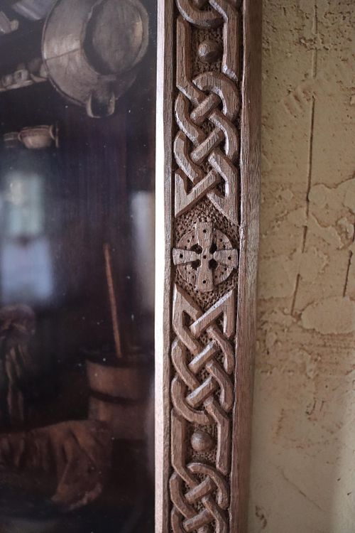 detail photo of Celtic knots and cross on carved walnut frame