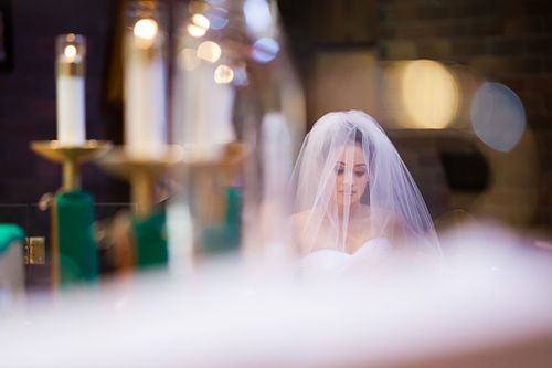 Bride and candles at alter sacweddingphotography