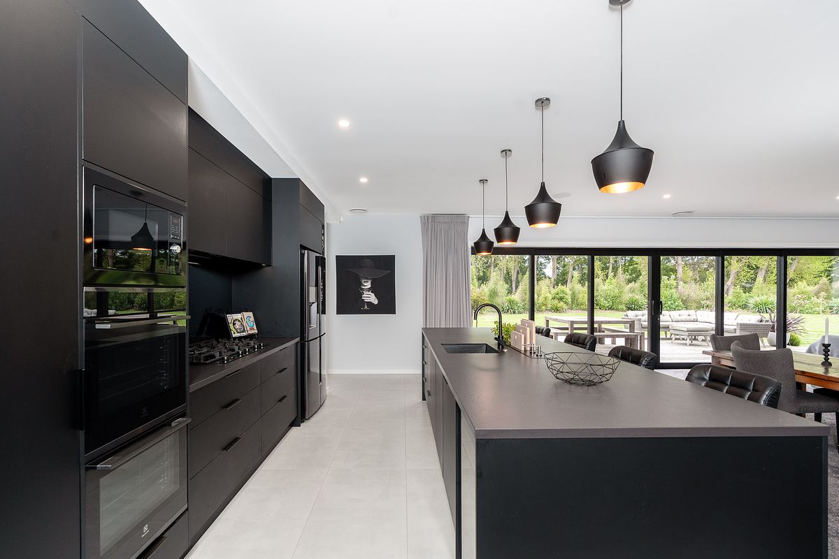 Luxury interior photography of a modern black kitchen in Tamahere by Flax Cove Studio.