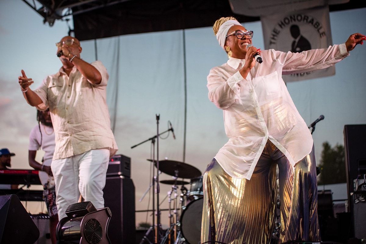 Live performance photography capturing Kindred the Family Soul on stage during a Philadelphia community celebration, highlighting energy, artistry, and cultural connection.