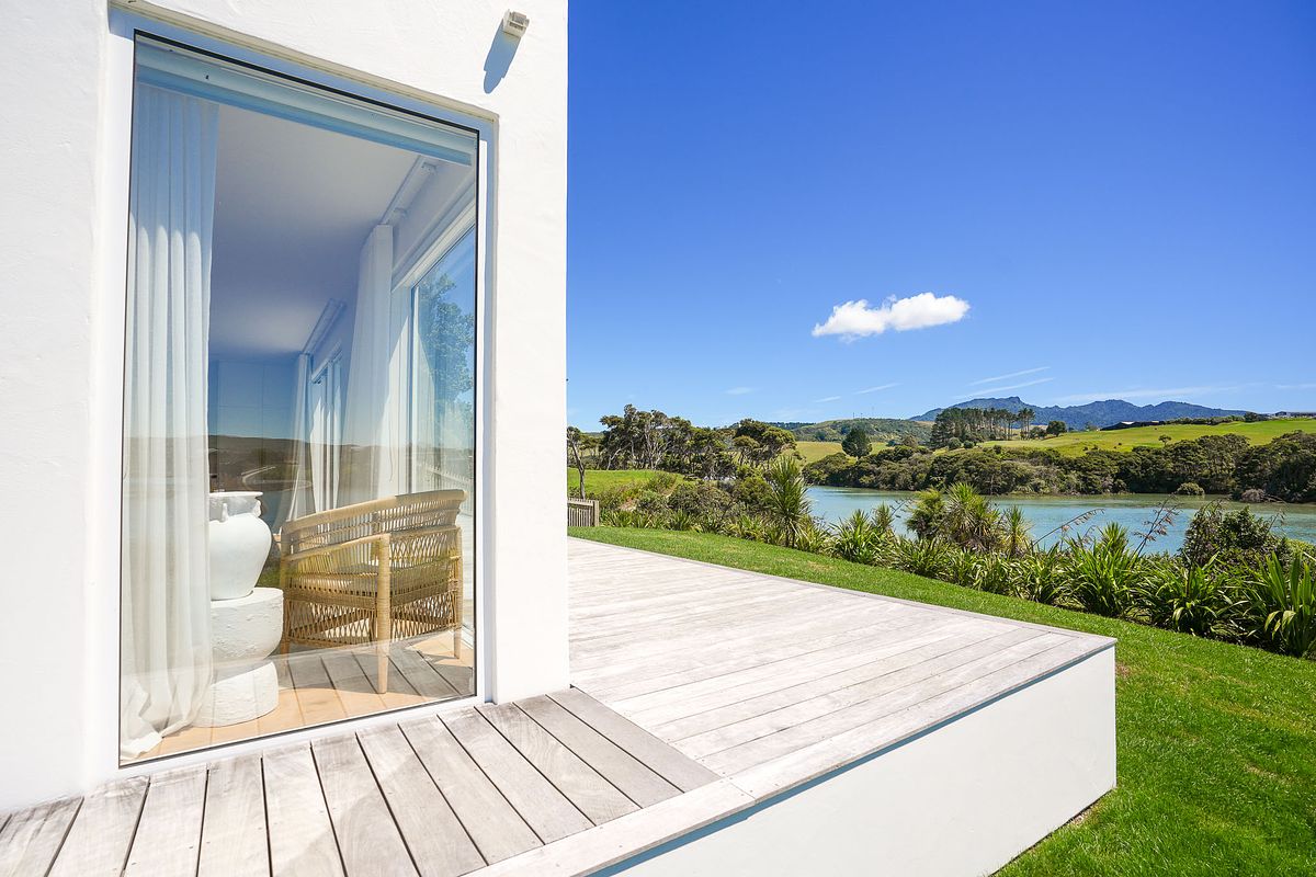 Exterior architectural photography of a Mediterranean style home overlooking Manu Bay, Raglan by Flax Cove Studio.