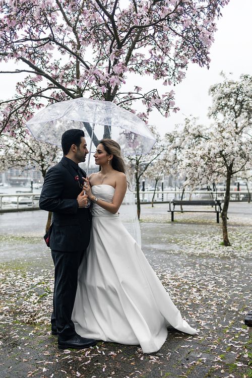 Spring wedding couple walking together in the rain in Vancouver