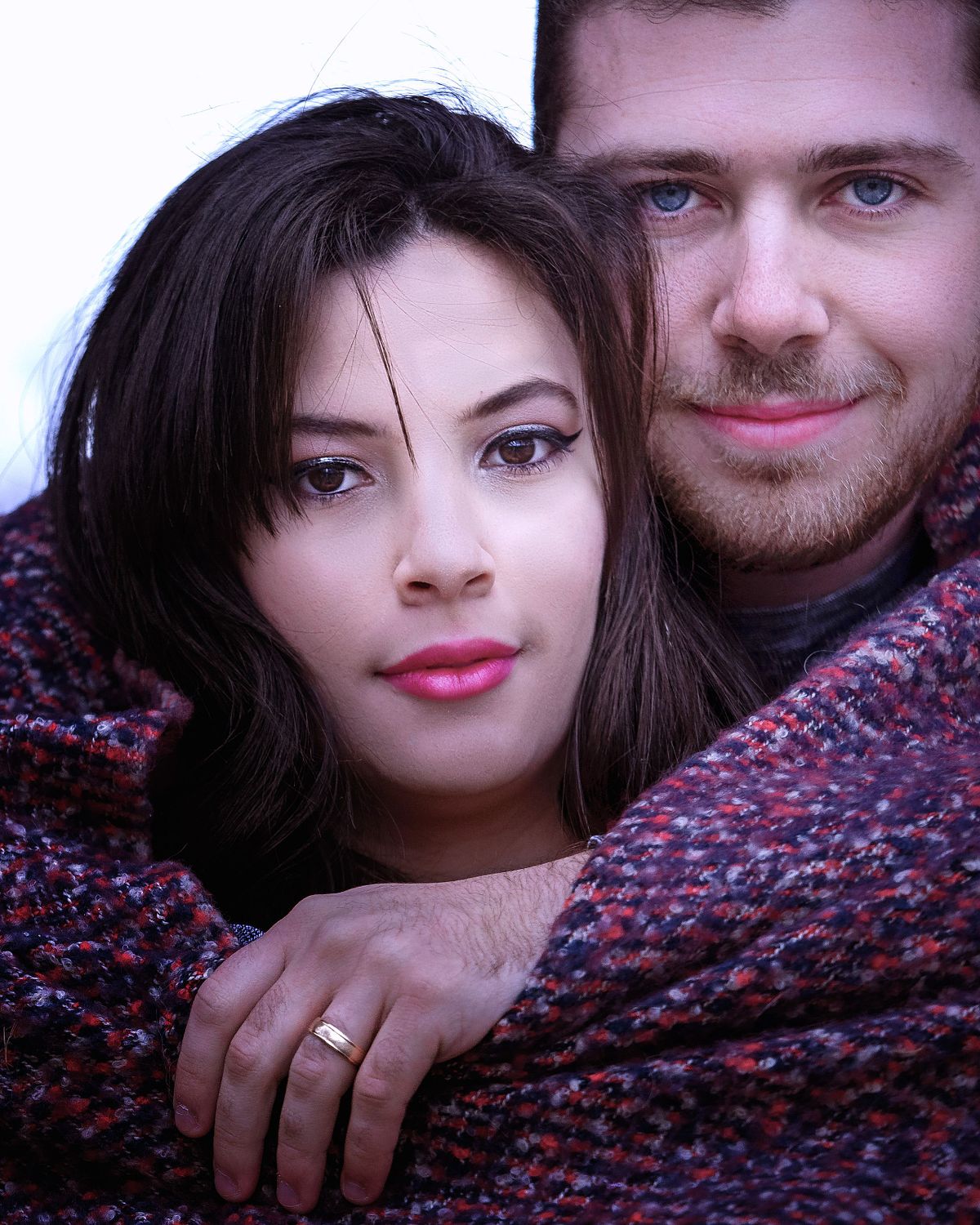 close-up of couple wrapped in a scarf