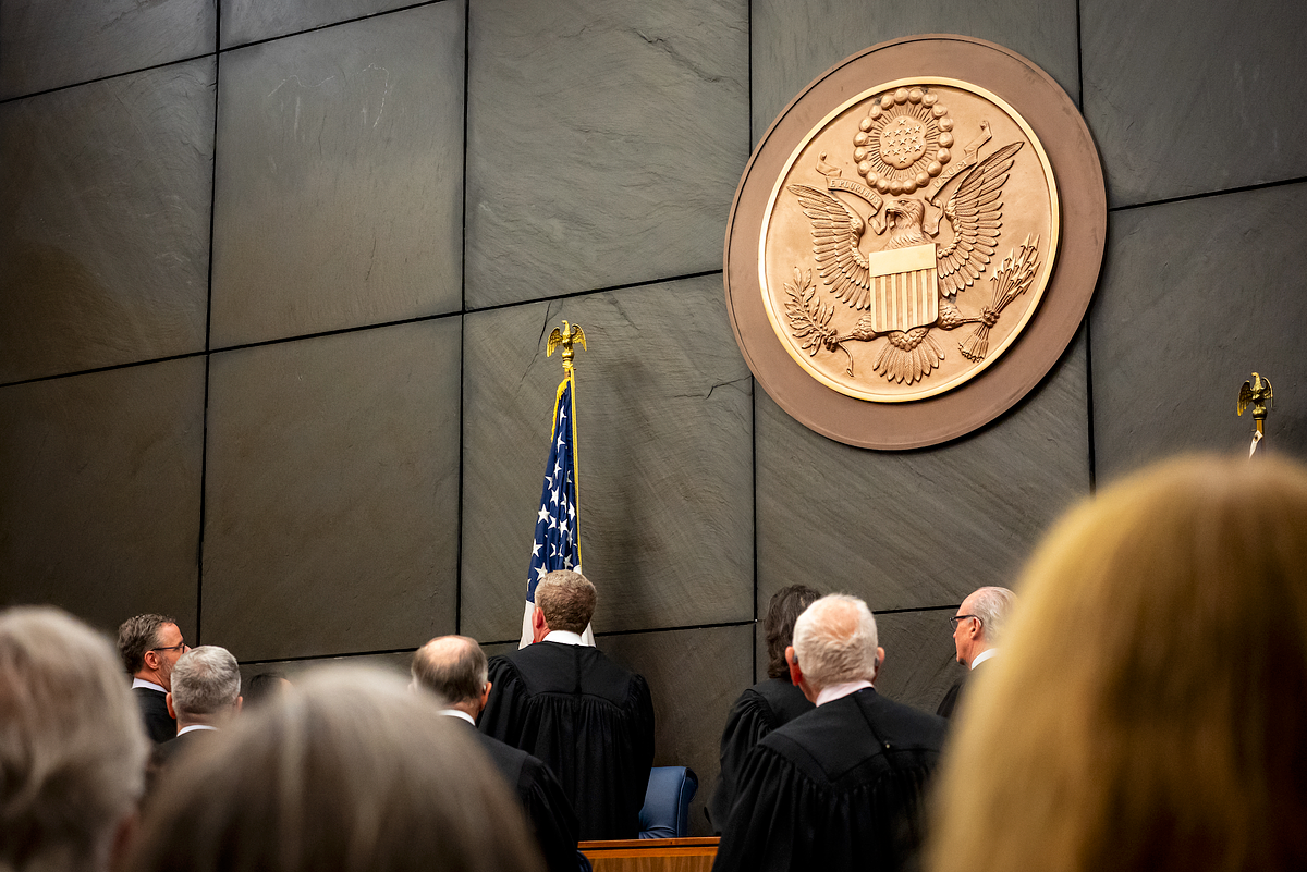 Federal judges standing beneath the United States seal during a judicial investiture ceremony in Philadelphia, documenting a formal leadership and institutional event.