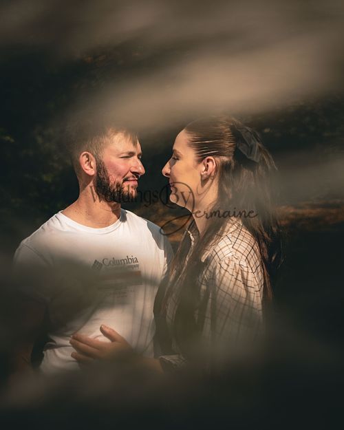 Alex and Shelby captured through flowers during their engagement shoot in Oadby Botanical Gardens, photographed by Weddings by Jermaine, showcasing their love surrounded by nature