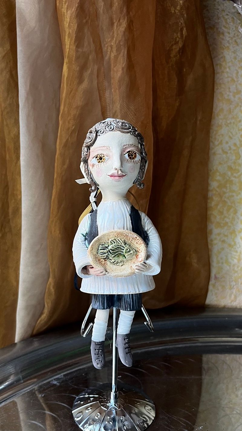 Traditional boy with a fish, little ceramic hanging sculpture