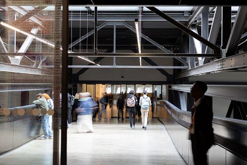 Blurred motion of visitors walking inside modern museum, Stockholm lifestyle photography