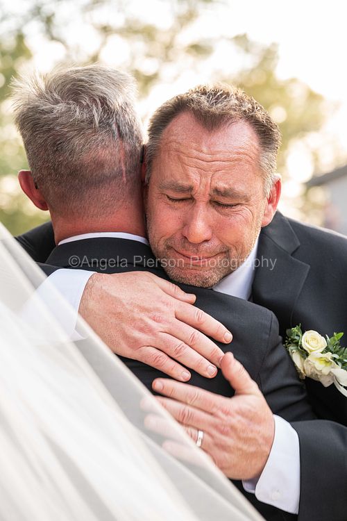 Groom and Best Man in emotional embrace -black hills wedding photographer