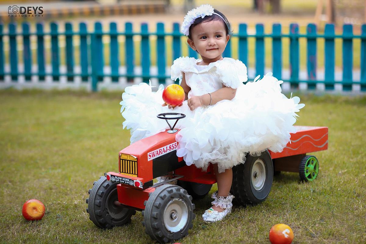 Baby playing with tractor photoshoot