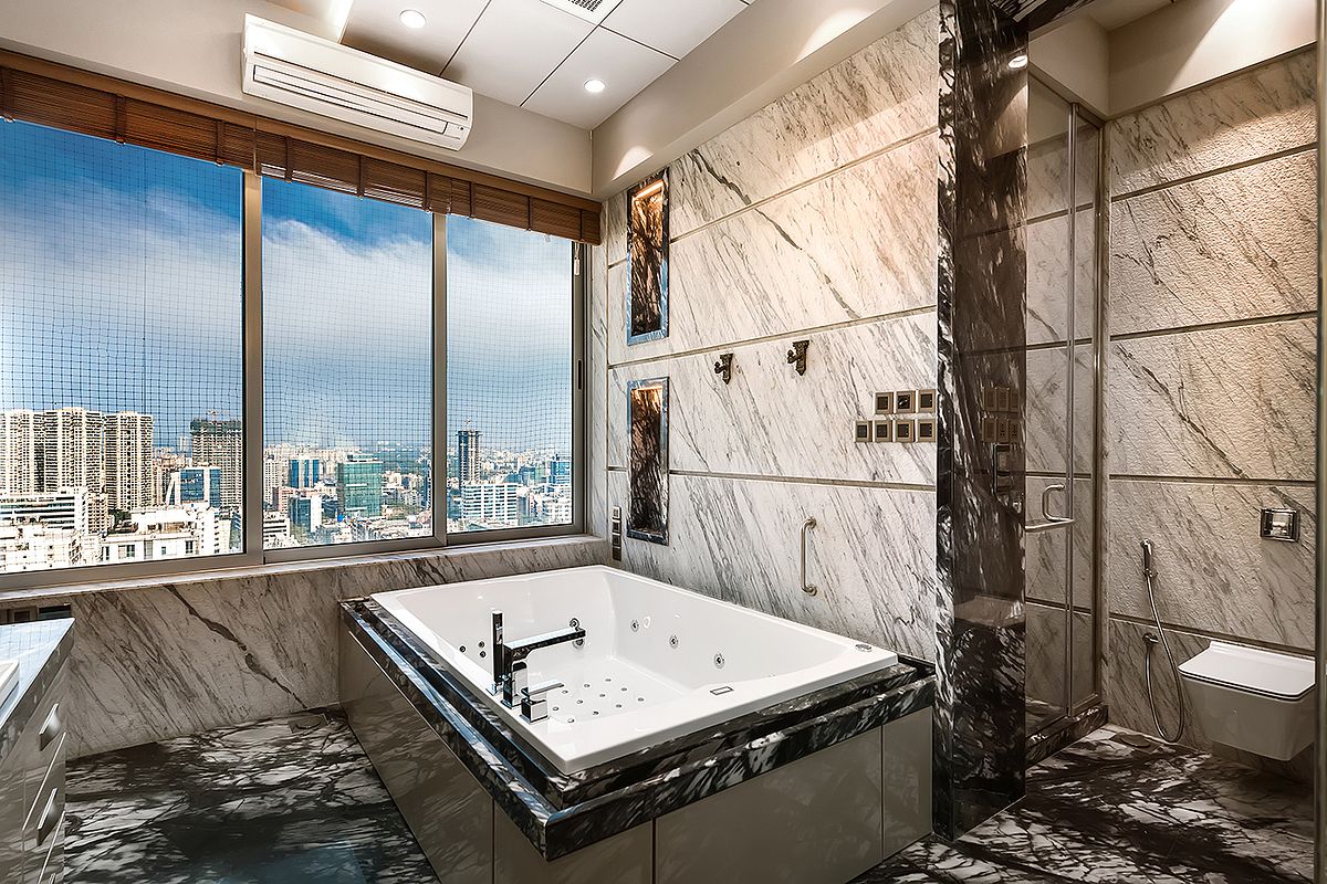 interior photographer : Lavish bathroom design with an stylish jacuzzi bathtub in a high rise duplex apartment by Interior Photographer Akkil Suvarna