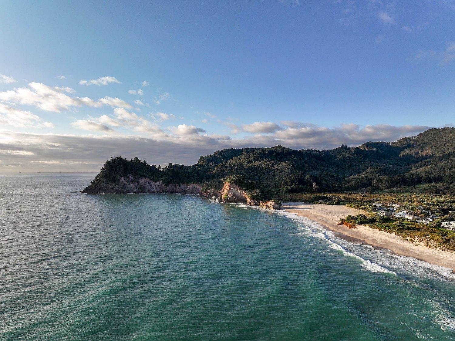 Cinematic drone photography of a luxury beachfront home in Whiritoa by Flax Cove Studio