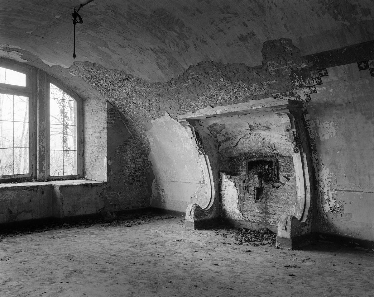 Fireplace and remnants of decorations at Fort V