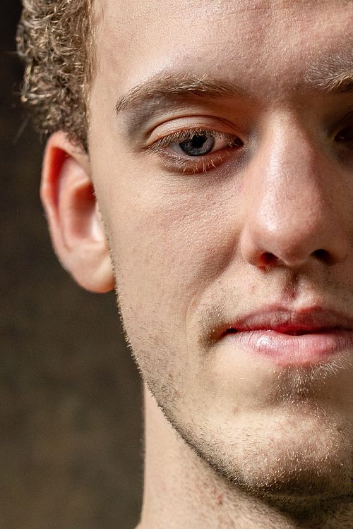 Extreme close-up portrait of a young man’s face with detailed skin texture, photographed in Stockholm by Mats Karlsson.