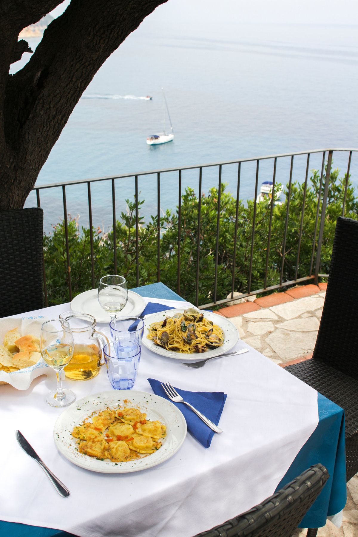 Restaurant table set for lunch with sea view, visual content for hospitality and dining brands