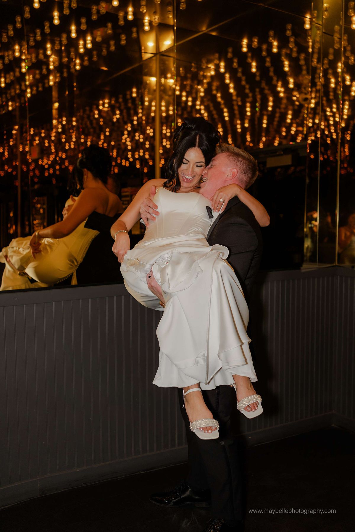 Romantic elopement photos at Carousel Bar in Downtown Las Vegas with couple celebrating with champagne