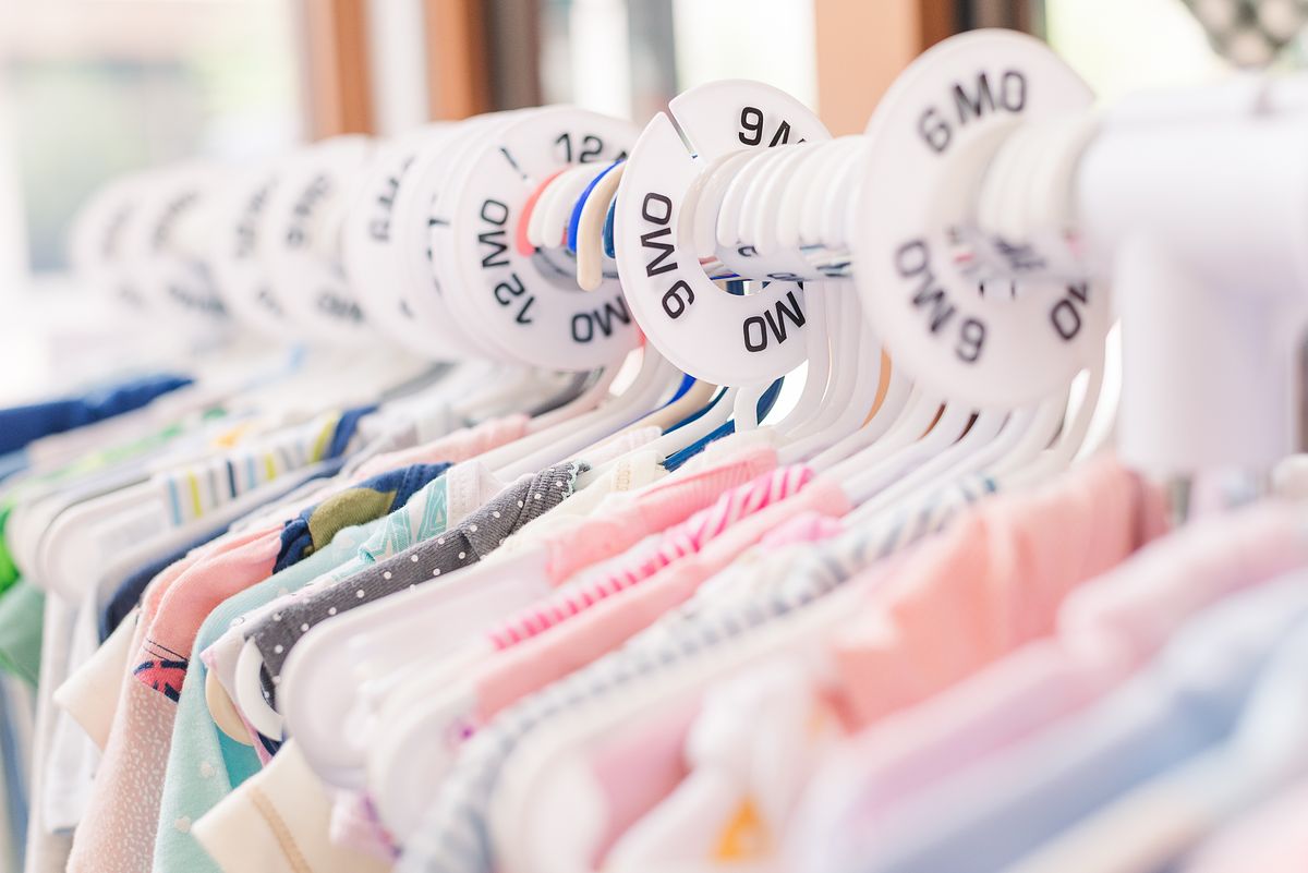 Rack of baby clothing ranging in sizes starting from newborn