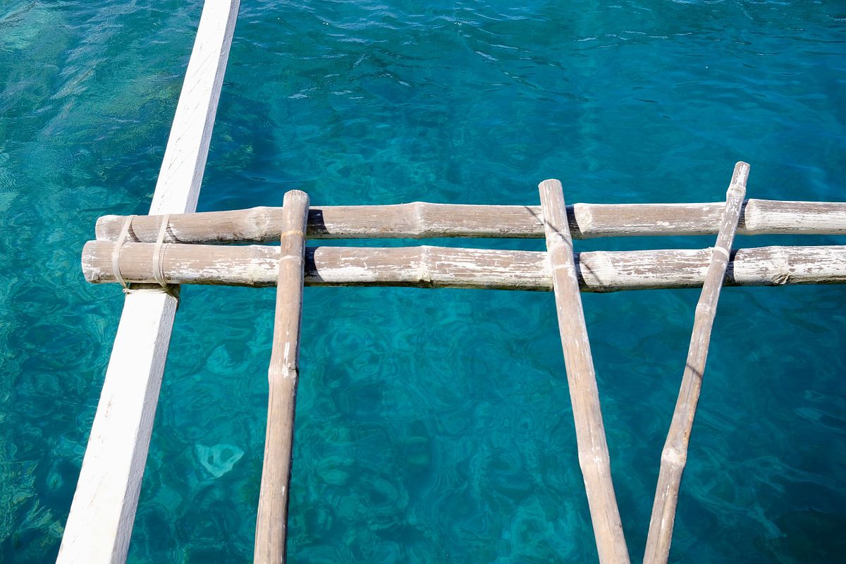 Beautiful blue ocean with bamboo boat detailing