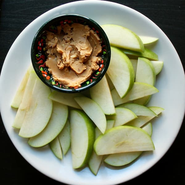 healthy snack of sliced apples and nut butter