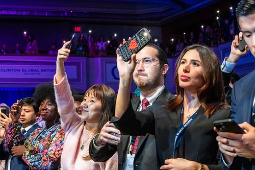 Audience members capturing a powerful moment on their phones during the Future of Funding session at Clinton Global Initiative 2024 in Philadelphia, photographed by professional event photographer.