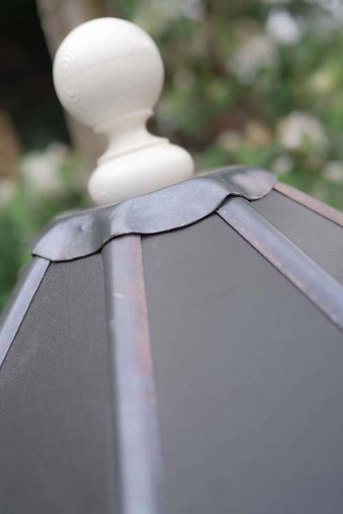 Close-up of the roof detail on a handmade garden structure, photographed outdoors