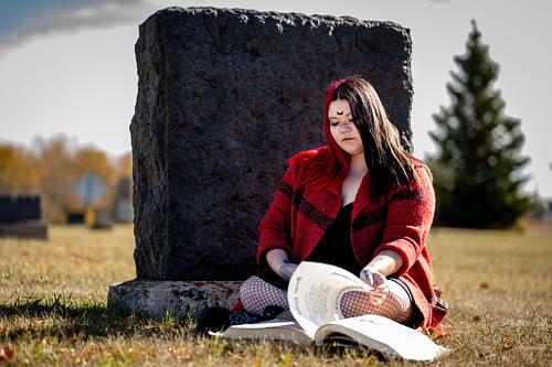 A witch researches in the graveyard.