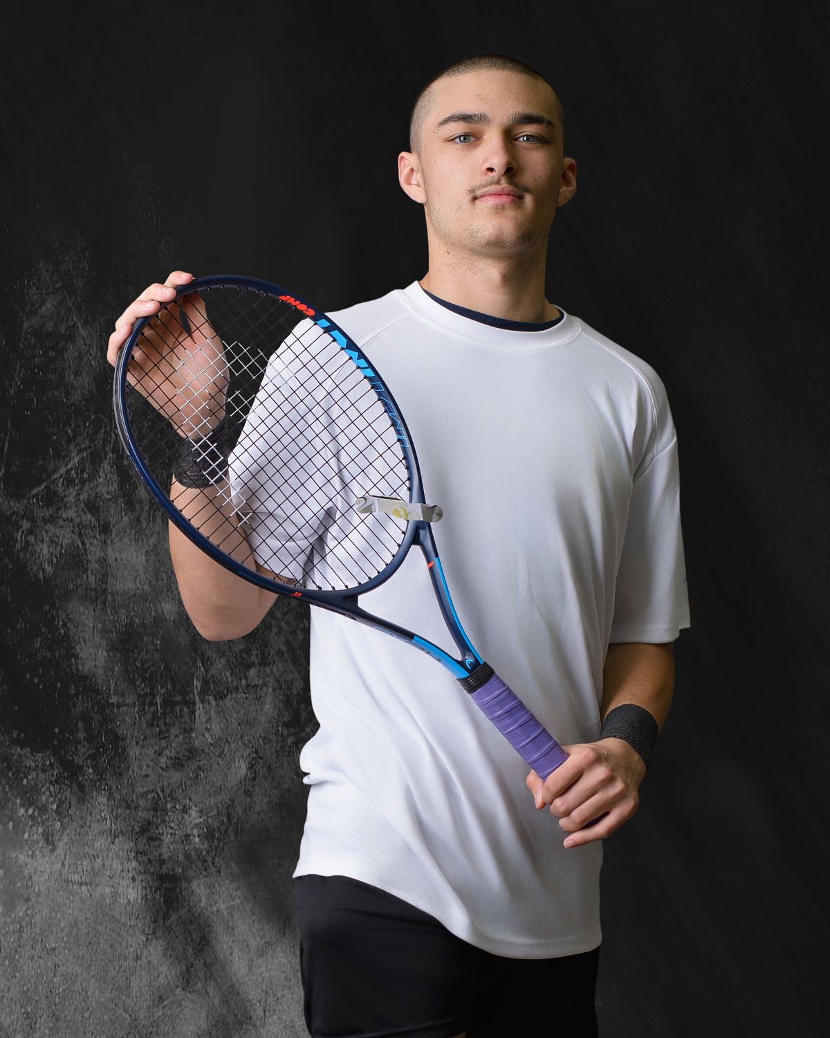 Male high school tennis player sportrait on a grunge background