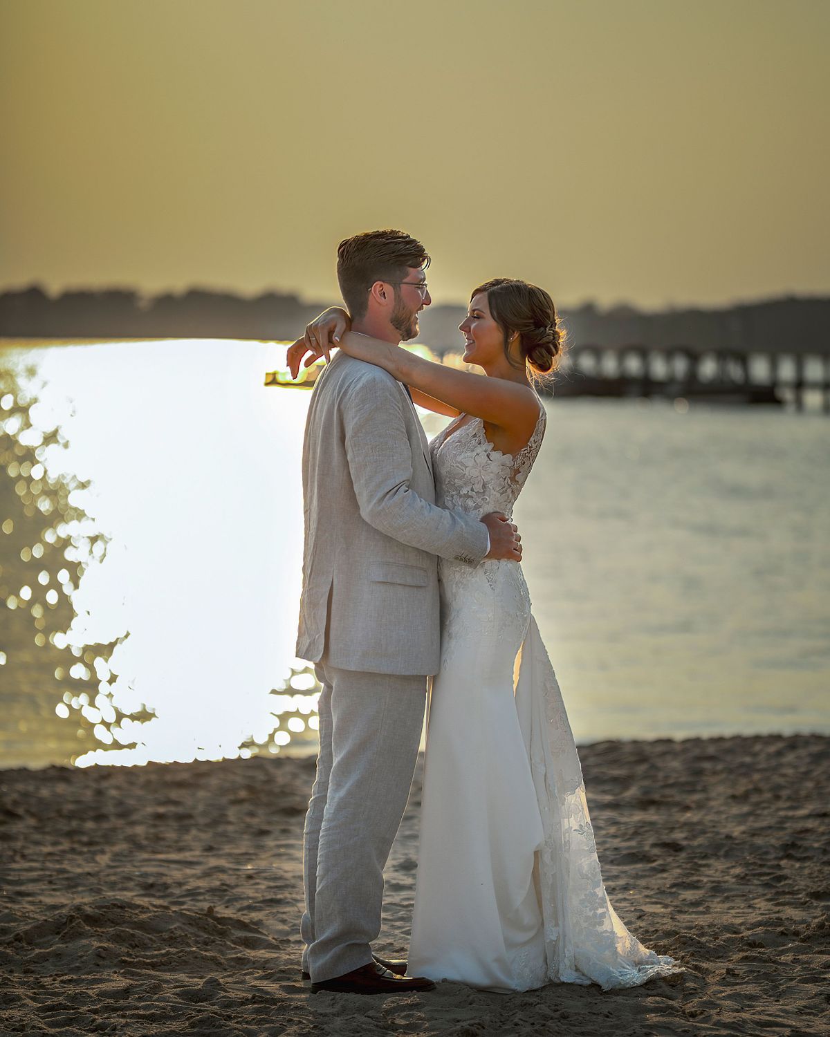 Bride and groom posing on the beach in dewey beach, delaware