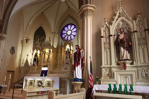The restored statue of Saint Joseph on the side altar showing the context of the sanctuary at Holy Trinity Catholic Church in Somerset, Ohio