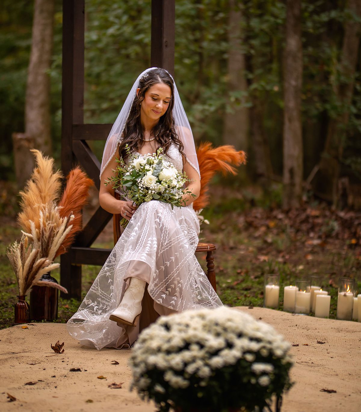 The bride is sitting underneath the arbor after the ceremony of a eastern shore forest wedding