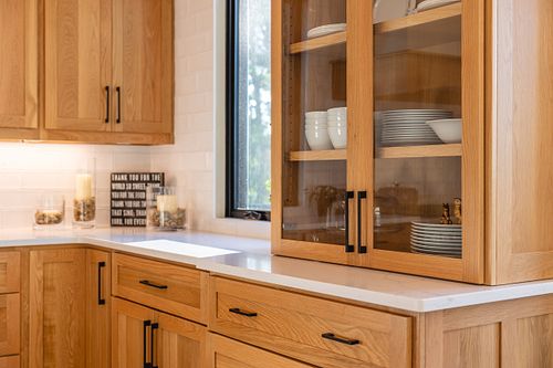 close up of glass door cabinet next to window