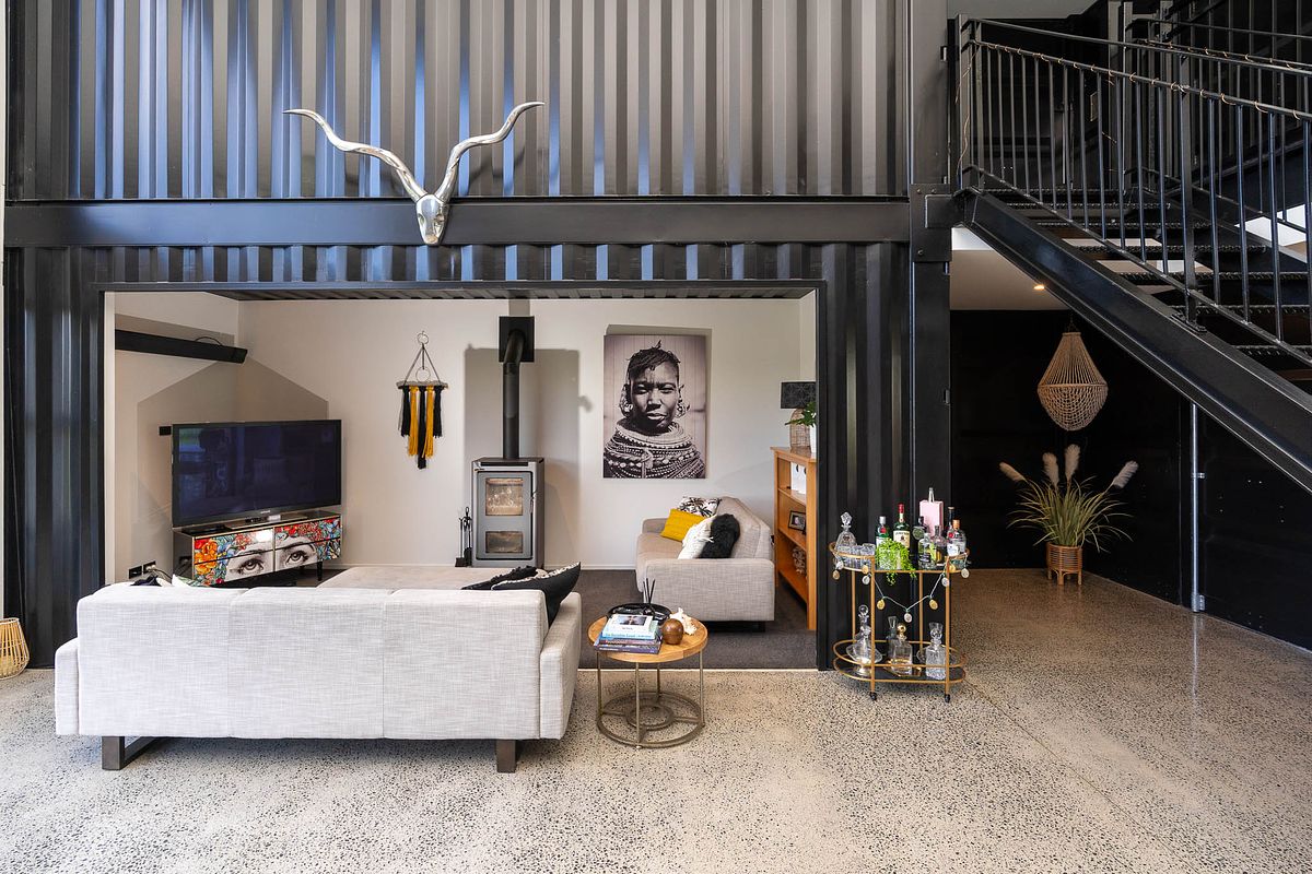 Architectural photography of the modern exterior and glass entrance of a luxury bespoke container home in Tamahere by Flax Cove Studio.