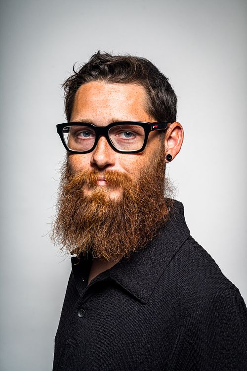 Creative angle studio portrait of Tim with strobes on white background — contemporary portrait by David Andrade, Las Vegas