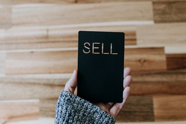 image of a phone that displays "sell" text. Indicating selling
