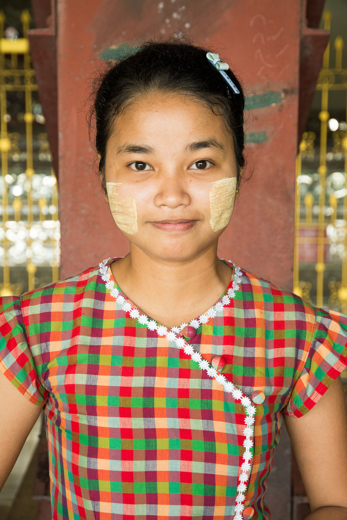 Girl in Myanmar wearing traditional Thanaka on her face