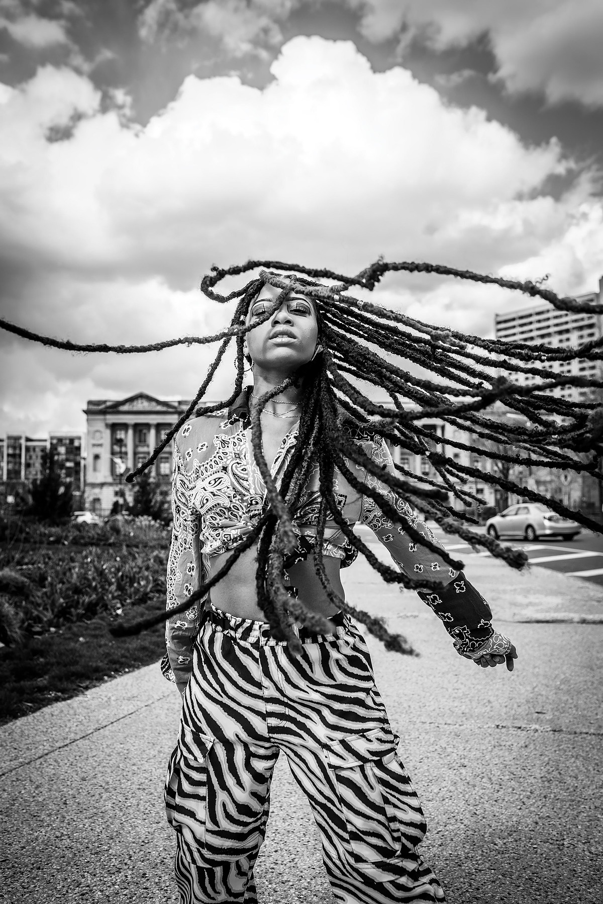 Black woman with long locs in motion in Philadelphia, expressive portrait capturing movement, presence, and natural hair freedom