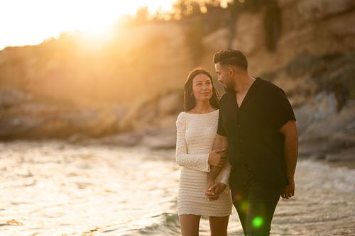 coppia passeggia in spiaggia al tramonto