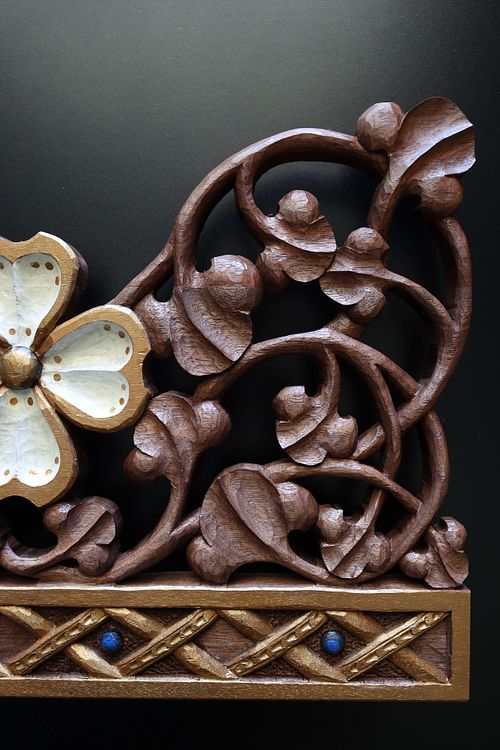 detail of scrolling vines and dogwood blossom on hand-carved tabernacle crown