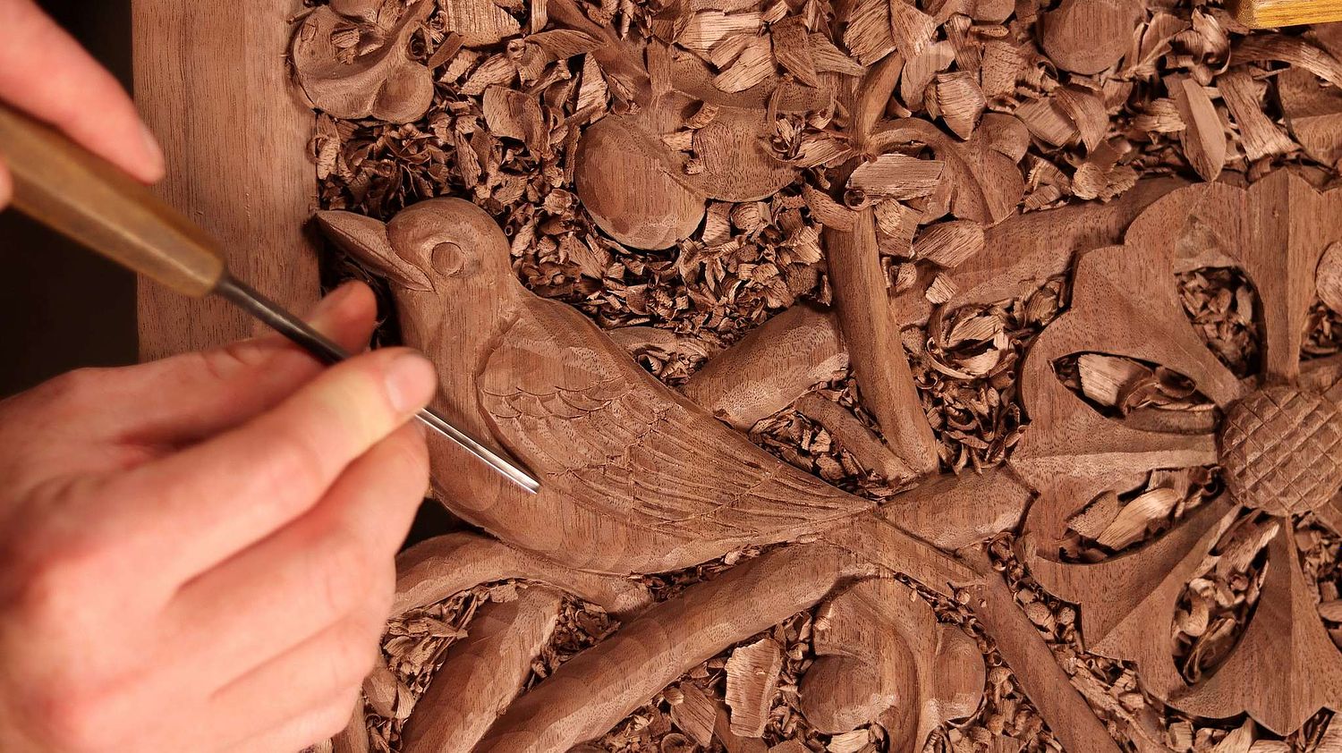 Wes Baker carving a robin on a door panel for a large shrine for St. Bernadette Catholic Church in Lancaster, Ohio