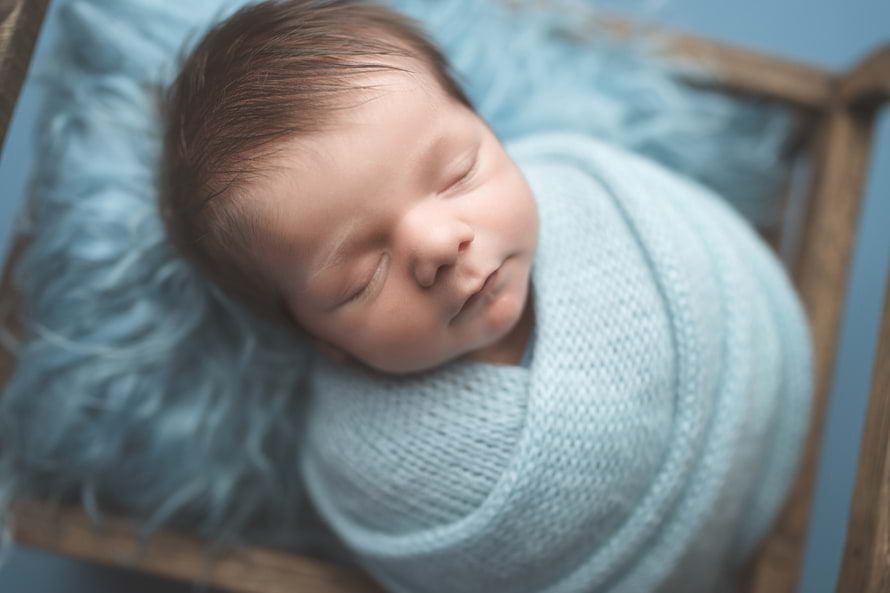 Beautiful baby boy sleeping peacefully captured by Cypress Newborn Photographer