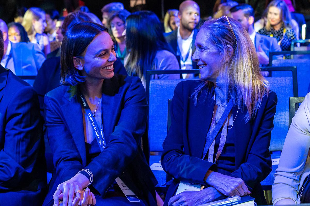 Corporate event photography capturing two attendees sharing a lighthearted conversation during the Clinton Global Initiative in New York City, highlighting authentic connection, collaboration, and leadership.