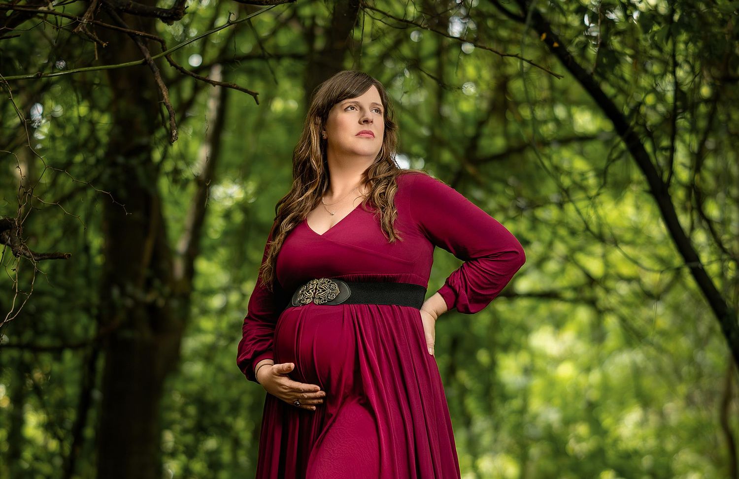 Pregnant woman posing in a forest during a maternity photography session in Savannah, Georgia.
