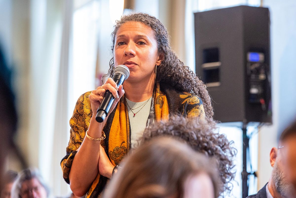 Corporate event photography capturing an attendee asking a question during a leadership conference Q&A session in Philadelphia, highlighting authentic engagement, voice, and professional presence.