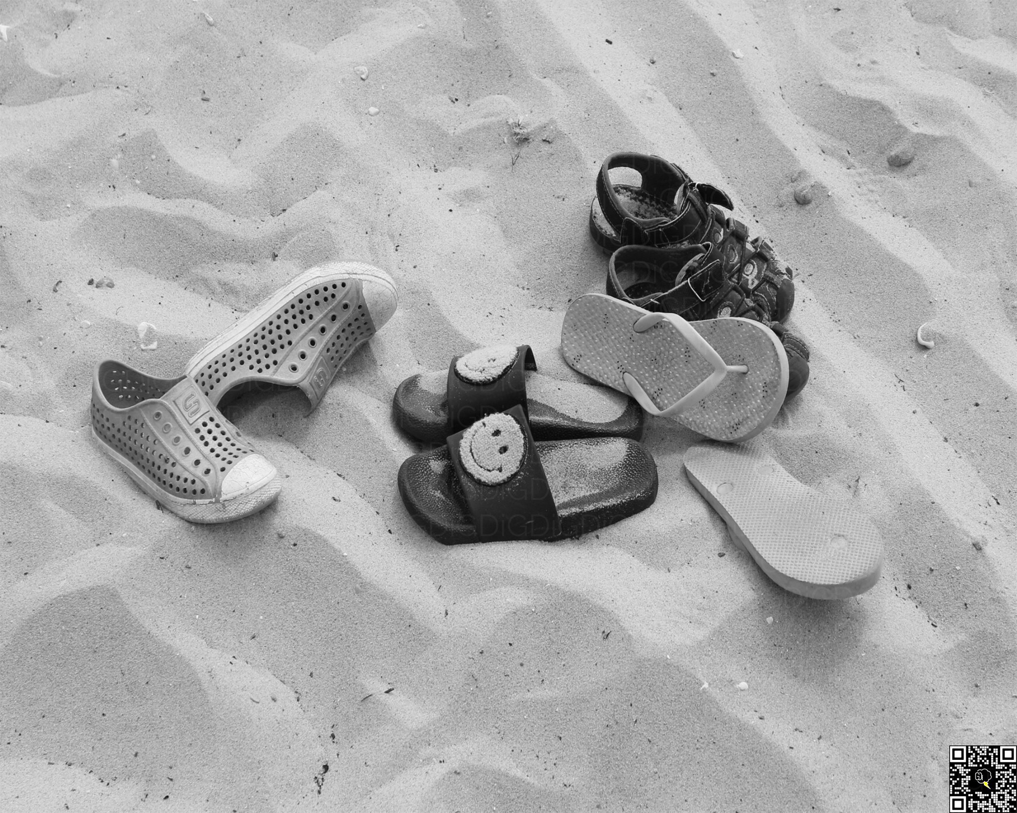 Tiny sandals resting on golden sands.