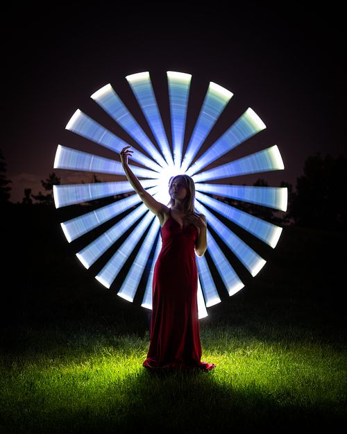 Grad photo of an Edmonton student in a circle of slivered light.