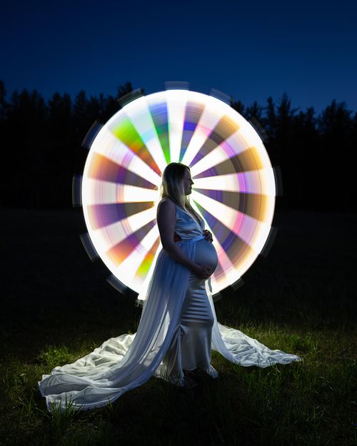 Creative maternity portrait using light painting.