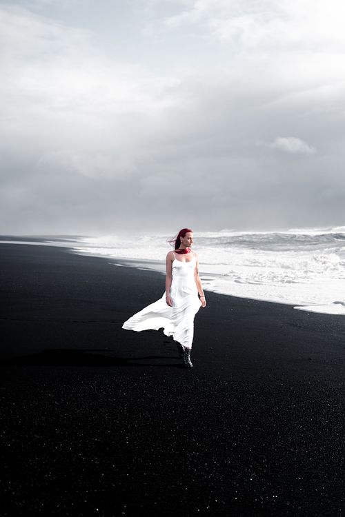 White dress photoshoot on black sand beach in South Iceland